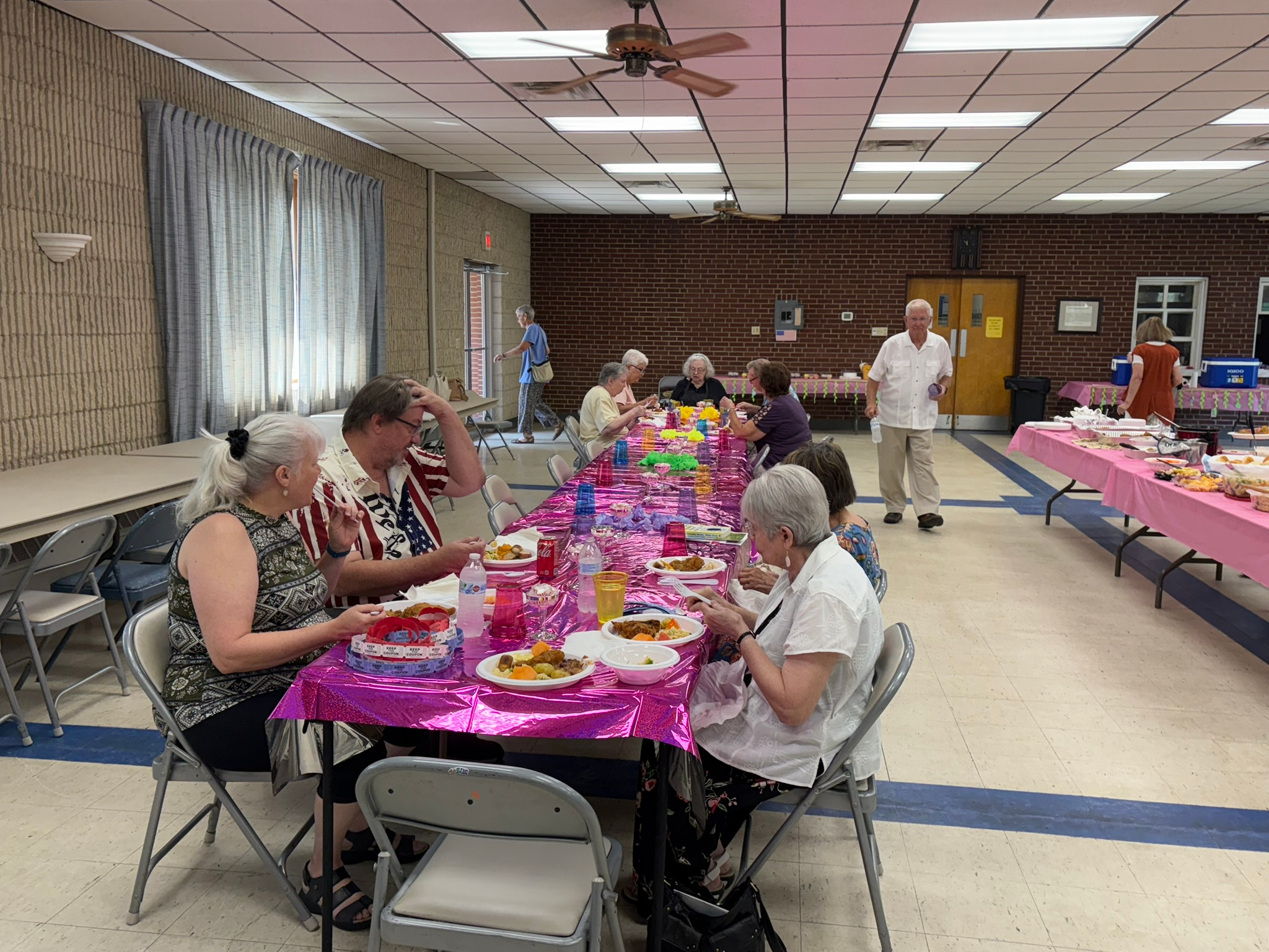 people eating at tables at the GVPC Summer Picnic